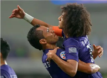  ?? Photo by Ryan Lim ?? Al Ain’s Dyanfres Douglas and Omar Abdulrahma­n celebrate a goal against El Jaish. —