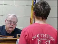  ?? Arkansas Democrat-Gazette/BILL BOWDEN ?? Elkins District Judge Ray Reynolds talks to a defendant during a recent night court session. In warmer months, members of the First Baptist Church grill hot dogs in the parking lot for people waiting to face the judge.