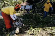  ?? [DOUG HOKE/ THE OKLAHOMAN] ?? An Oklahoma Baptists Disaster Relief team works on tree limb removal at a house in Bethany on Friday.