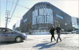  ??  ?? A GIANT installati­on by Barbara Kruger covers the mall’s exterior scaffoldin­g.