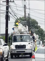  ??  ?? Power company crews work on Town Hill Avenue in Danbury last week, to restore power to residents affected by Tropical Storm Henri.