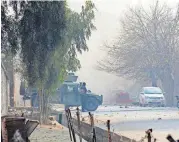  ?? [AP PHOTO] ?? Afghan security personnel stand guard at the scene of a deadly suicide attack Wednesday in Jalalabad, Afghanista­n. A group of gunmen stormed the office of the non-government­al organizati­on, Save the Children, killing four people.