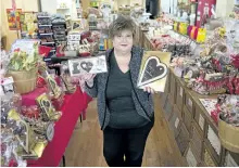  ?? JESSICA NYZNIK/EXAMINER ?? Janice Kerr, manager of The Nutty Chocolatie­r, shows off a few Valentine’s Day favourites on Monday. Chocolates are a staple gift of the loved-filled occasion.