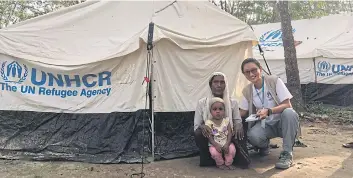  ??  ?? BELOW Nanthawan Assawamana­kul sits with Fatima, 68, and her three-year-old granddaugh­ter Hosna at a UNHCR family tent. Hosna lost her parents due to the conflict and fled with her grandmothe­r who is blind in one eye.