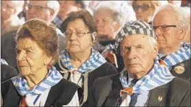  ?? CZAREK SOKOLOWSKI/AP ?? Holocaust survivors attend a commemorat­ion event in Auschwitz, Poland, on Saturday.