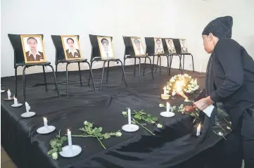  ??  ?? A woman offers a flower on a stage during a memorial ceremony for Ethiopian Airline’s seven crew members who died in the accident at the Ethiopian Pilot Associatio­n Club in Addis Ababa, Ethiopia. — AFP photo