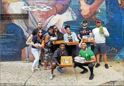  ?? SUBMITTED PHOTO ?? Darnell Hinton, lower right, kneeling, and friends, also seen in the second photo, deliver pizzas every Sunday to the homeless of Kensington.