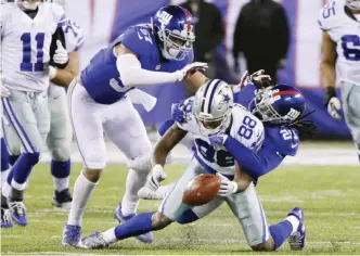  ??  ?? EAST RUTHERFORD: Dallas Cowboys wide receiver Dez Bryant (88) fumbles the ball during the second half of an NFL football game as New York Giants’ Janoris Jenkins (20) and Keenan Robinson (57) defend Sunday, in East Rutherford, N.J. — AP
