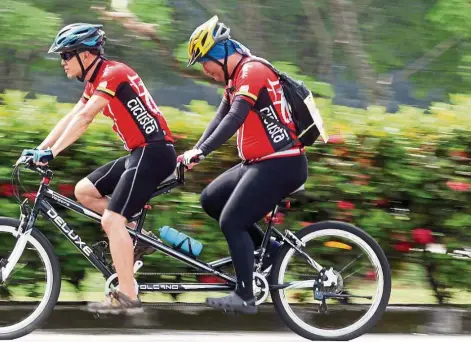  ??  ?? d cyclist Jeffrey Ng riding tandem. — Photos: Filepics