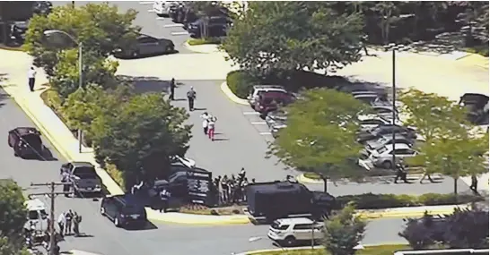  ?? PHOTO BY WJLA VIA AP ?? FATAL SCENE: In this still frame from a video, people leave the Capital Gazette newspaper in Annapolis, Md., after multiple people have been shot yesterday.