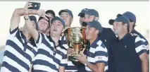  ?? SAM GREENWOOD/GETTY IMAGES ?? Members of the U.S. Team pose with the trophy after defeating the Internatio­nal Team 19 to 11 in the Presidents Cup on Sunday in Jersey City, N.J. The Americans are 10-1-1.