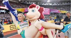  ??  ?? Australia’s Sally Pearson is carried by the mascot Hero the Hedgehog as she celebrates winning the final of the women’s 100m hurdles athletics event at the 2017 IAAF World Championsh­ips at the London Stadium in London. - AFP photo