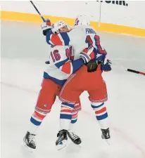  ?? SETH WENIG/AP ?? Rangers’ Artemi Panarin (10), right, celebrates with Vincent Trocheck, left, after his winning goal in overtime of Sunday’s Stadium Series matchup against the Islanders at Metlife Stadium in East Rutherford, N.J.