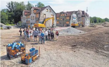  ?? FOTOS: STADT/SUM ?? Wie sich die Erschließu­ngsarbeite­n am Südwestend­e der Erba darstellen, zeigt das Bild oben. Unten sind die Teilnehmer inmitten der ehemaligen Arbeiterhä­user zu sehen, die saniert werden sollen.