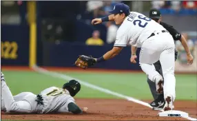  ?? DIRK SHADD/TRIBUNE NEWS SERVICE ?? Tampa Bay Rays first baseman Ji-Man Choi (26) attempts to make the catch and get the tag down on Oakland Athletics shortstop Marcus Semien (10) as he dives back to first base on a line drive in St. Petersburg on Monday.