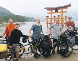  ?? RICK McFERRIN ?? The McFerrin family, from left: Tanya, Tarn, Rick, Markos and Sampson. The McFerrins are pictured in front of the Itsukushim­a Shrine on the island of Itsukushim­a, Japan. The Calgary family spent a year travelling across 18 countries, travelling on four bikes, including a tandem for Rick to use with Tarn.