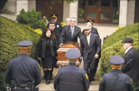  ?? Jeff Swensen / Getty Images ?? The casket of Irving Younger is led to a hearse outside Rodef Shalom Temple following his funeral on Oct. 31 in Pittsburgh.