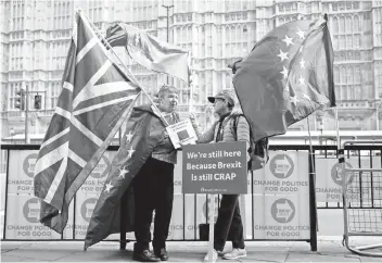  ?? — Reuters photo ?? Anti-Brexit protesters hold flags outside the Houses of Parliament in London, Britain.