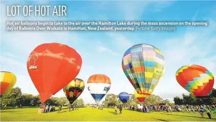  ?? Picture: Getty Images ?? Hot air balloons begin to take to the air over the Hamilton Lake during the mass ascension on the opening day of Balloons Over Waikato in Hamilton, New Zealand, yesterday.