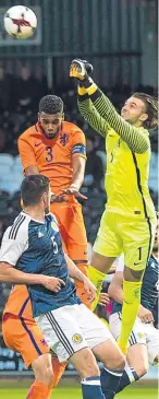 ?? SNS. ?? Stevie Mallan, above, is congratula­ted after firing home Scotland’s second goal, while Dutch keeper Joel Drommel punches clear.