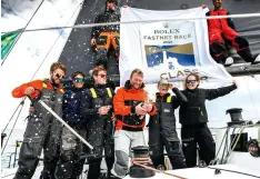  ??  ?? Thomas Kneen’s JPK 1180 Sunrise crew celebrate after winning IRC overall and Class 2 - the first British winning boat in a decade