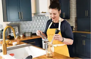  ?? CYDNI ELLEDGE/THE NEW YORK TIMES ?? Author Lindsay-Jean Hard cooks with bananas May 5 in Ann Arbor, Michigan. Hard is an expert on no-waste cuisine and wrote a book about cooking with scraps.