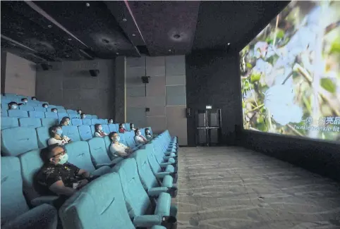  ?? STR/AFP ?? People watch a movie at a cinema in Hangzhou yesterday.