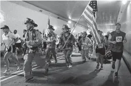  ?? MIKE STOCKER/ SOUTH FLORIDA SUN SENTINEL FILE ?? Then Fort Lauderdale Deputy Fire Chief Robert Hoecherl, far right, runs through the Henry Kinney Tunnel as part of the second Stephen Siller Tunnel to Towers Run. Hoecherl was arrested Thursday for misdemeano­r driving under the influence.