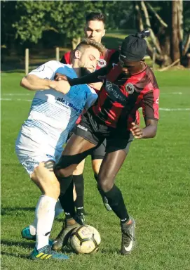  ??  ?? Paul Kuol tussles with a Malvern opponent for the ball during Warragul United’s 2-3 loss on Saturday in men’s State 1 action. Photograph­s by Amanda Emary.