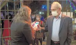  ?? MAYA ALLERUZZO/AP ?? A man presents his “green passport,” proof that he is vaccinated against the coronaviru­s, on opening night at the Khan Theater in Jerusalem on Feb. 23.