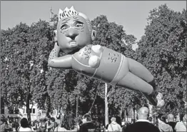  ?? TIM IRELAND/AP ?? Protesters set things up Saturday before releasing a caricature balloon of London Mayor Sadiq Khan over Parliament Square. Organizers raised over $75,000 to create the blimp.