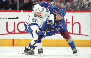  ?? RON CHENOY/ USA TODAY SPORTS ?? Avalanche center Tyson Jost and Lightning center Brayden Point battle for the puck Feb. 10. Colorado won both matchups this season by one goal, the first in a shootout.