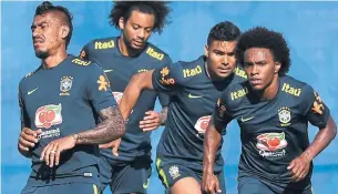  ?? NELSON ALMEIDA/AFP/GETTY IMAGES ?? From left to right, Brazilians Paulinho, Marcelo, Casemiro and Willian will have to put memories of the 2014 semifinals behind them. They’re among the tournament favourites, as always.