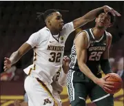  ?? STACY BENGS — THE ASSOCIATED PRESS ?? Michigan State’s Malik Hall (25) is fouled by Minnesota’s Sam Freeman (32) during the second half of Monday’s game in Minneapoli­s. Minnesota won 81-56.