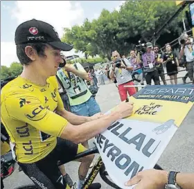  ?? FOTO: AP ?? El maillot amarillo del Tour, Geraint Thomas, firmando antes de tomar la salida de ayer