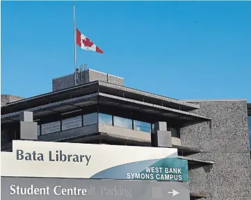  ?? CLIFFORD SKARSTEDT EXAMINER ?? The Canadian flag flies at half-mast atop Trent University's Bata Library on the Symons Campus on Saturday after the university announced the death of founding president Thomas H.B. Symons.
