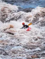  ??  ?? Kayaker Adam Quinn maneuvers through the Souse Hole rapid on the Rio Grande on Tuesday.