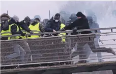  ?? EPA ?? Christophe Dettinger, right, kicks a French gendarme on the ground during violent clashes in Paris