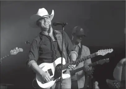  ?? The Sentinel-Record/Richard Rasmussen ?? ENTERTAINI­NG EVENING: Country music artist Justin Moore performs during the Forrest Wood Cup at Bank OZK Arena Sunday.