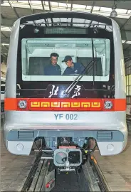  ?? XINHUA XU YANG / ?? Staff workers with the CRRC Changchun Railway Vehicles Co test a subway train to be used in Beijing’s Yanfang Line.