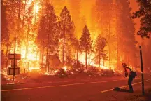  ?? MARCIO JOSE SANCHEZ/ASSOCIATED PRESS ?? Gabe Huck, a member of a San Benito Monterey Cal Fire crew, stands along state Highway 168 while fighting the Creek Fire on Sunday in Shaver Lake, Calif.