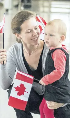  ?? BOB TYMCZYSZYN/ STANDARD STAFF ?? St. Catharines resident Olesya Galkina, who took the oath of citizenshi­p, is pictured with her two- year- old daughter Anna Galkin. Nineteen people received their Canadian citizenshi­p Tuesday at the Rainbow Bridge in Niagara Falls as part of Canada 150...