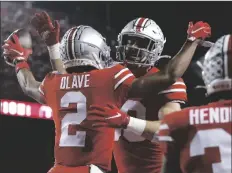  ?? JAY LAPRETE/AP ?? OHIO STATE RECEIVER CHRIS OLAVE (left) celebrates his touchdown against Penn State with tight end Jeremy Ruckert during the first half of a game Saturday in Columbus, Ohio.