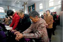  ?? PHOTO: REUTERS ?? Catholic believers take part in a weekend mass at an undergroun­d Catholic church in Tianjin, China.