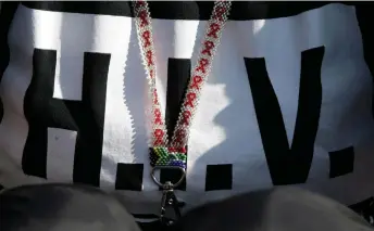  ?? — AFP file photo ?? File photo shows part of a necklace with the South African flag and of a piece of clothing with “HIV” written on it, during a march in Pretoria as members of South Africa The Treatment Action Campaign (TAC) say they could not support “lies” the government was telling the United Nations about its treatment programme.