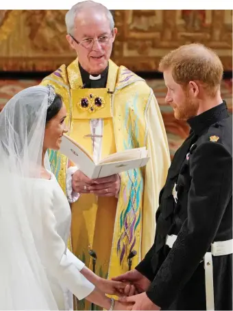 ??  ?? The real vows: Meghan, Harry and Archbishop Welby in St George’s Chapel