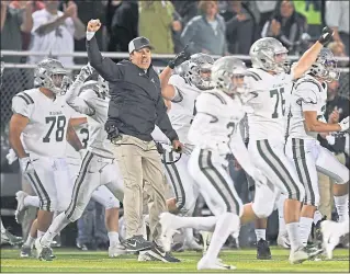  ?? JOSE CARLOS FAJARDO – STAFF PHOTOGRAPH­ER ?? De La Salle head coach Justin Alumbaugh celebrates with his players after defeating Bishop Gorman on Friday.