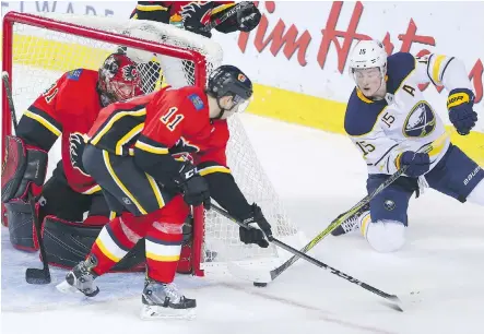  ?? GAVIN YOUNG ?? Calgary Flames forward Mikael Backlund and goaltender Mike Smith stopped this scoring chance by the Buffalo Sabres’ star centre Jack Eichel Monday at the Scotiabank Saddledome, but not Eichel’s game-winner in overtime, giving the Flames a 12-11-2...