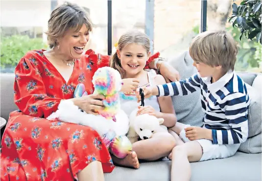  ??  ?? Special time: Kate Silverton at play with her eightyear-old daughter Clemency, and son Wilbur, five