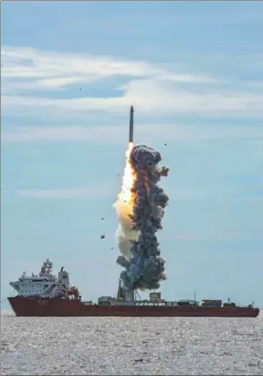  ?? SHI XIAO / FOR CHINA DAILY ?? Nine satellites are launched atop a Long March 11 carrier rocket from a self-propelled deck barge in the Yellow Sea on Tuesday, fulfilling China’s first commercial launch at sea.